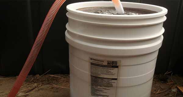 white bucket with compost tea